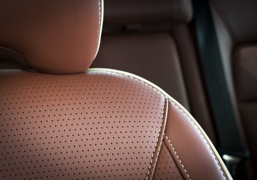 Part,Of,Red,Leather,Car,Seat,With,The,Unfocused,Car